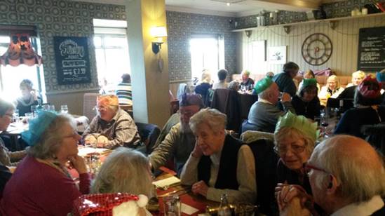 A group of people sitting at tables

Description automatically generated with medium confidence