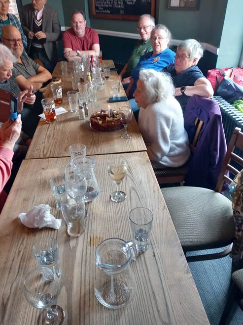 A group of people sitting at a long table

Description automatically generated