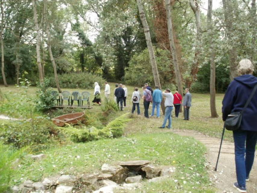 A group of people in a forest

Description automatically generated