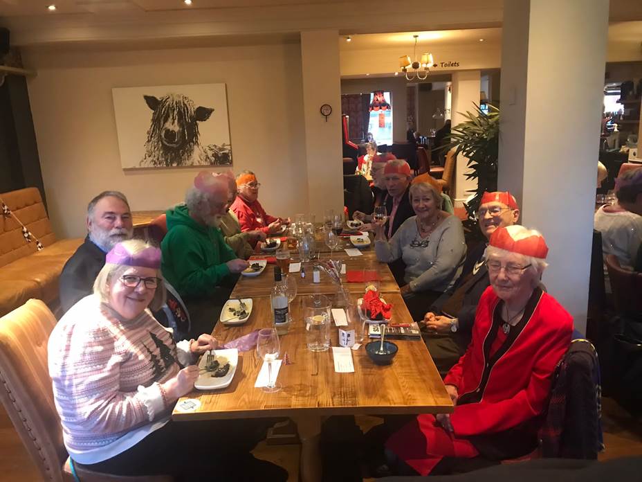 A group of people sitting at a table

Description automatically generated